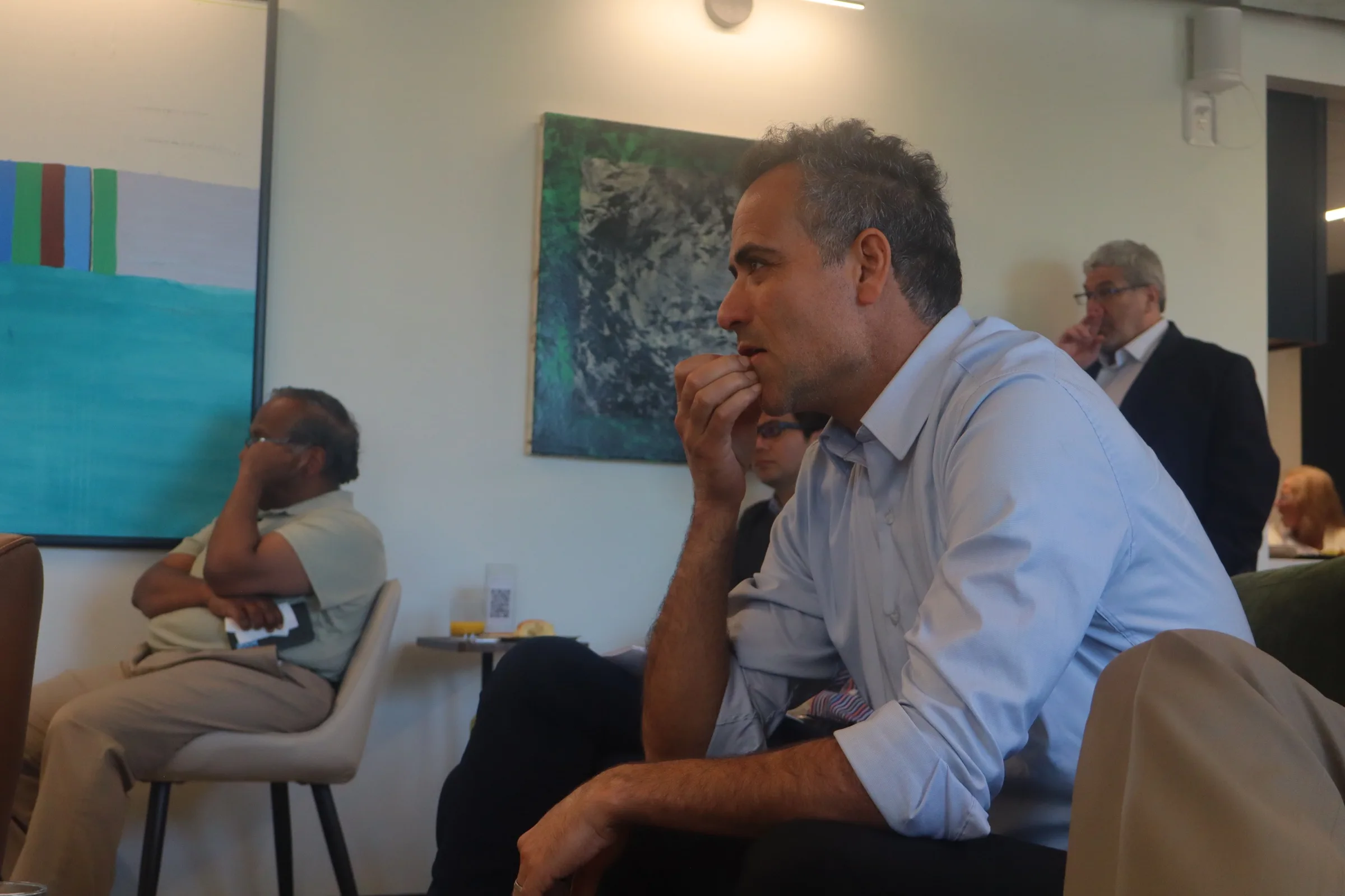 An audience member listening closely during a talk.
